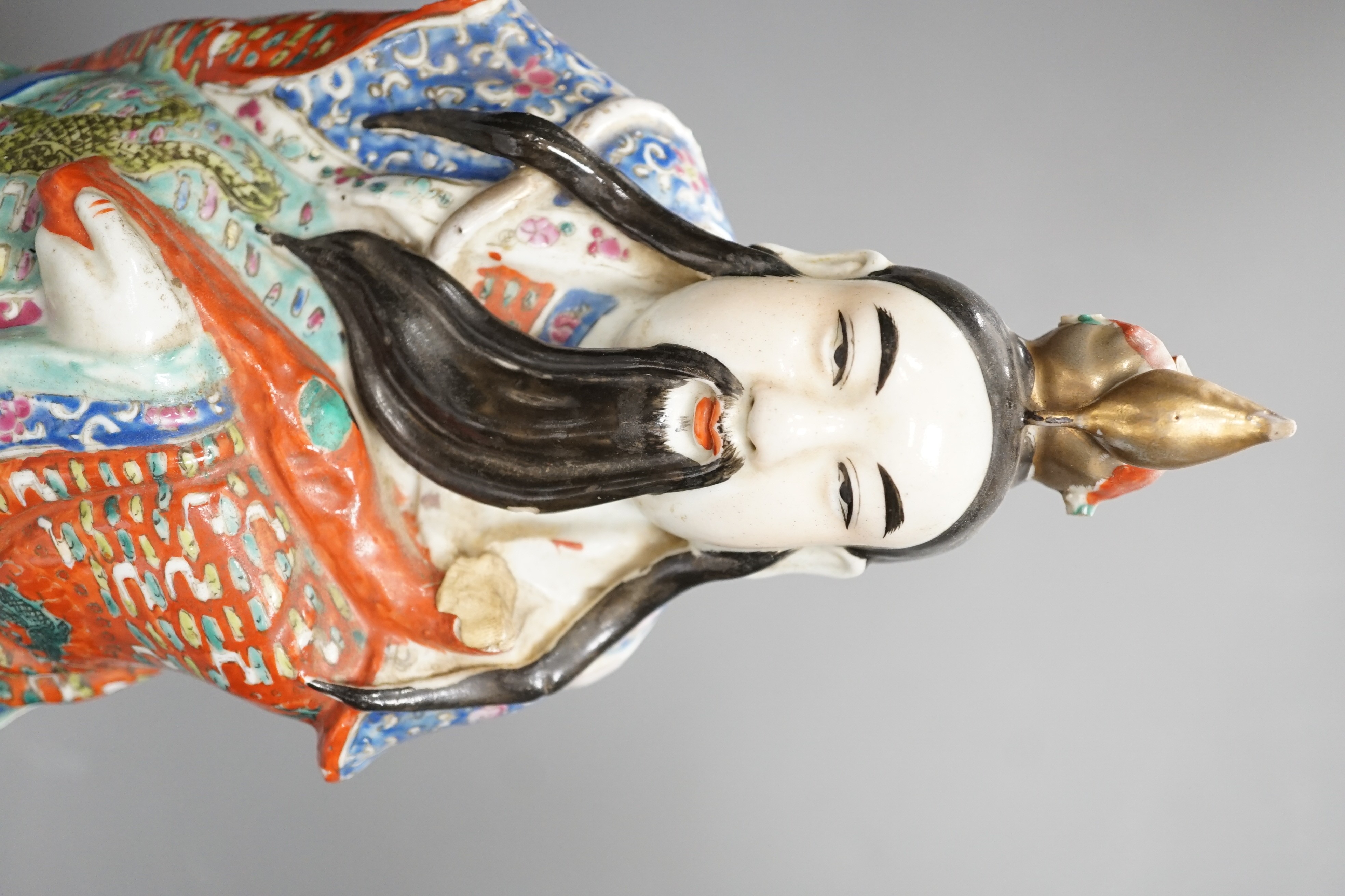 A Chinese enamelled porcelain figure of an immortal, early 20th century, 43cm